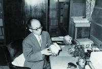 自宅で橋爪遺跡の土器を手に取る今里氏